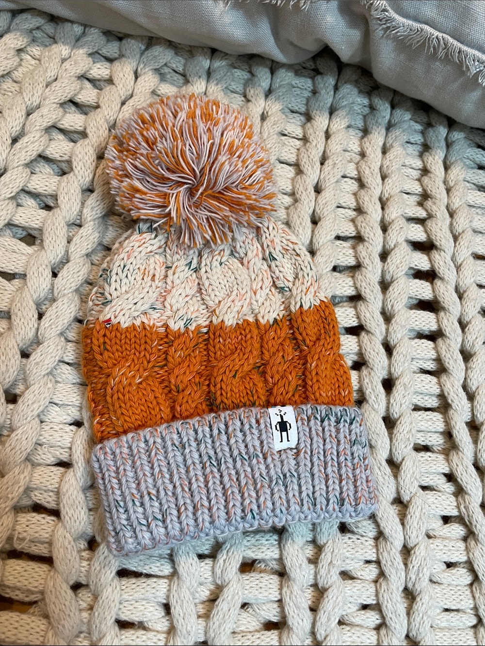 Smartwool Kids Isto Retro Cable Knit Pom Beanie in Orange and Cream and Gray